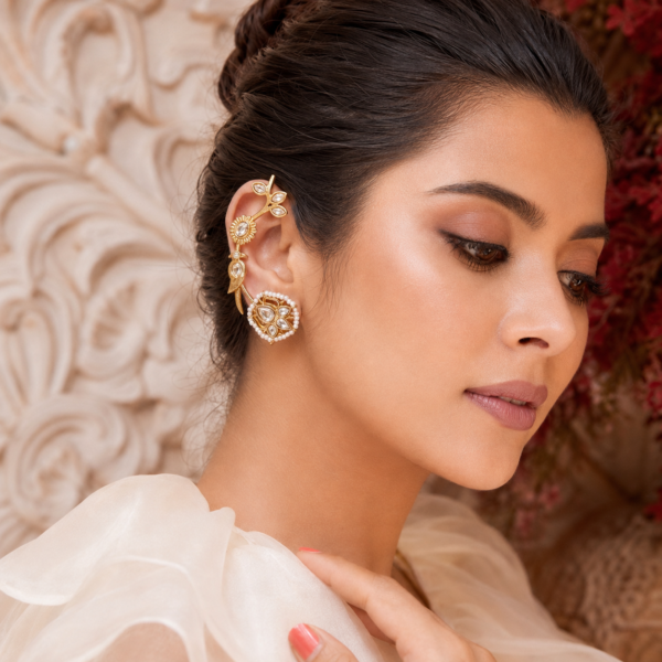Peacock ear cuff earrings with floral vine detailing, stone-like accents and pearl-like borders