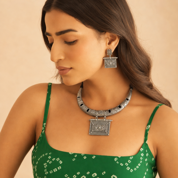 Oxidised necklace set with earrings featuring an engraved collar and rectangular floral pendant