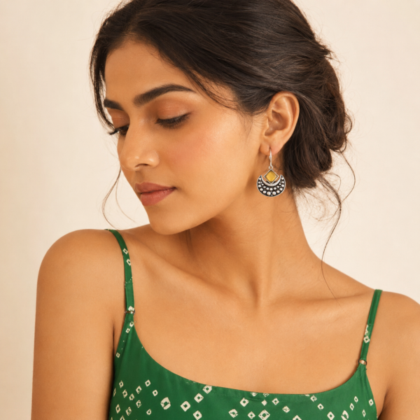 Oxidised drop earrings with geometric accents and crescent-shaped stone-like detailing
